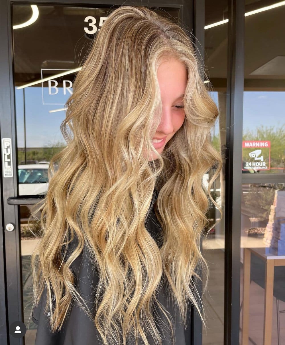 Golden blonde balayage with long beach waves and bright dimension in Chandler AZ