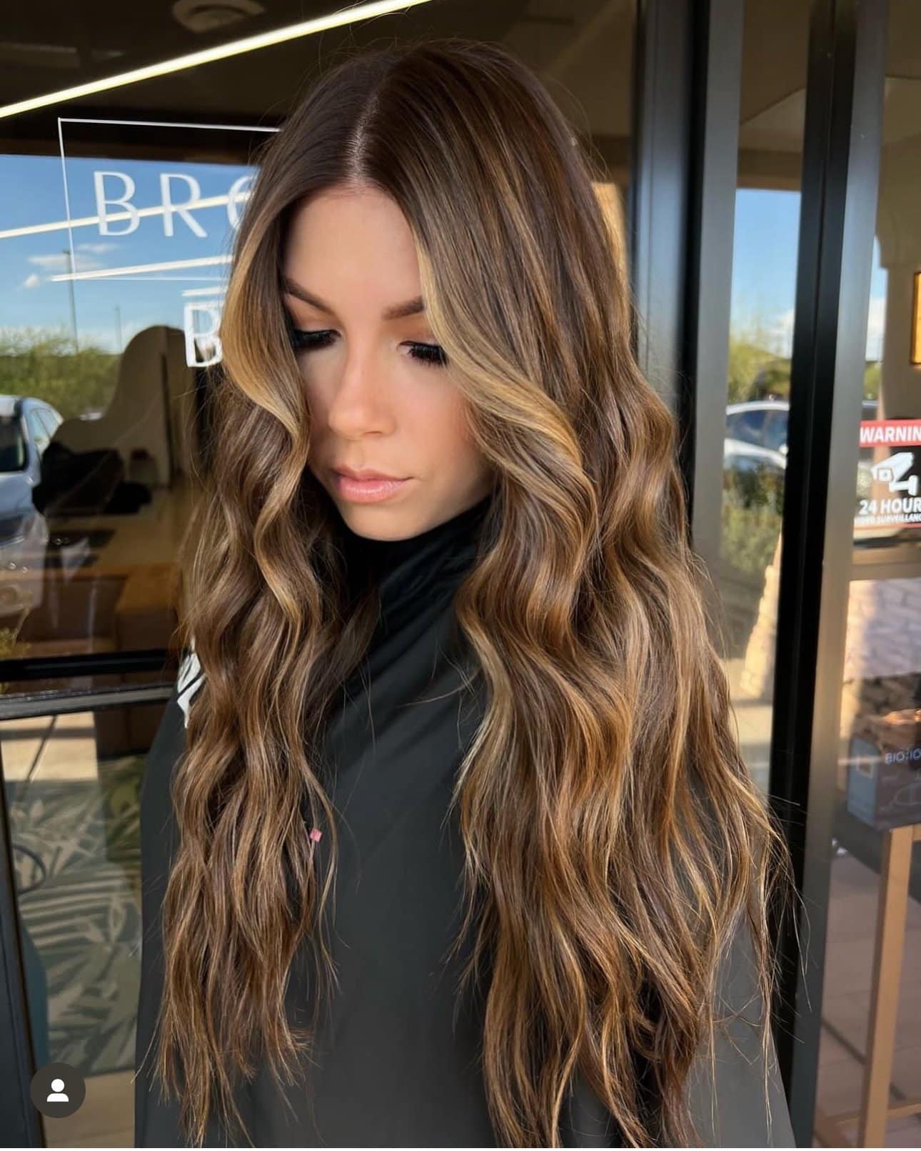 Warm brunette balayage with soft waves and natural blend at salon in Chandler AZ